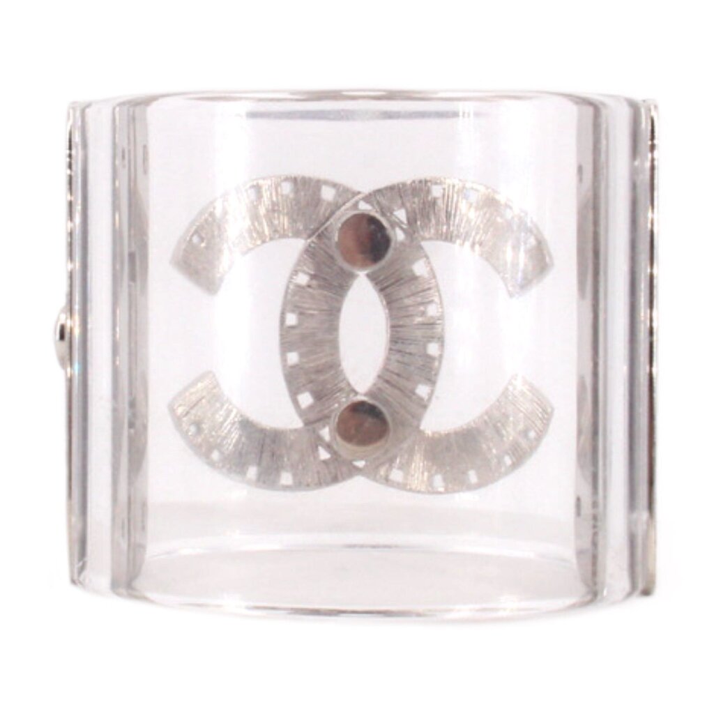 CHANEL clear cuff bracelet with a brushed silver interlocking logo and two dark round accents