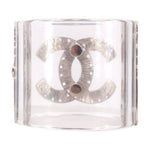 CHANEL clear cuff bracelet with a brushed silver interlocking logo and two dark round accents