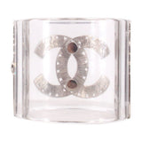 CHANEL clear cuff bracelet with a brushed silver interlocking logo and two dark round accents