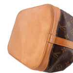 Louis Vuitton Petit Noe monogram shoulder bag with curved tan leather top panel