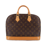 Monogram handle bag with tan leather handles and trim, zip top closure
