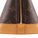 Monogram bag zipper close-up with tan leather pull and Louis Vuitton label