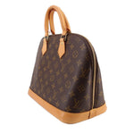 Monogram handle bag with tan leather bottom edge and side zipper detail