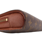 Louis Vuitton Orsay monogram clutch close-up of brown leather tab and textured edge