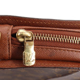 Louis Vuitton Orsay monogram clutch close-up of gold zipper pull with LV emblem
