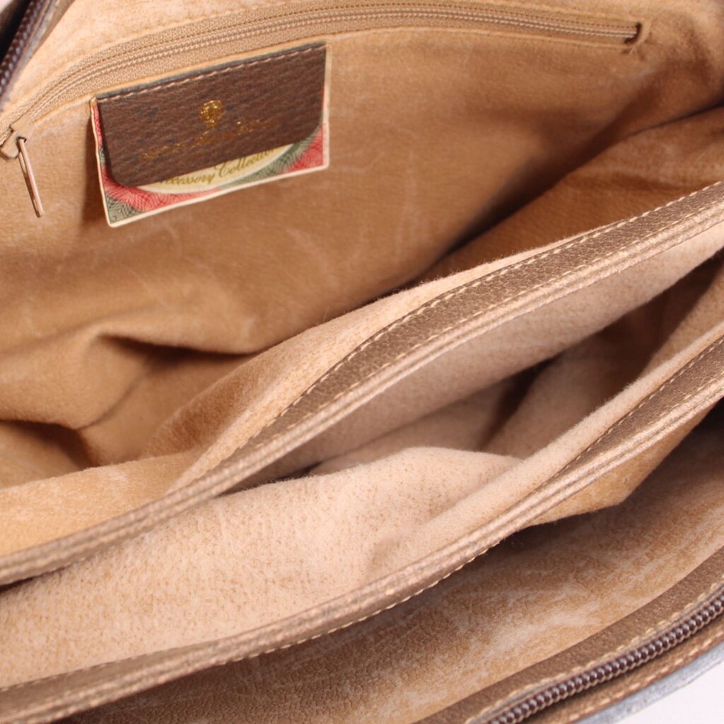 Beige suede-lined interior compartment with fabric logo patch