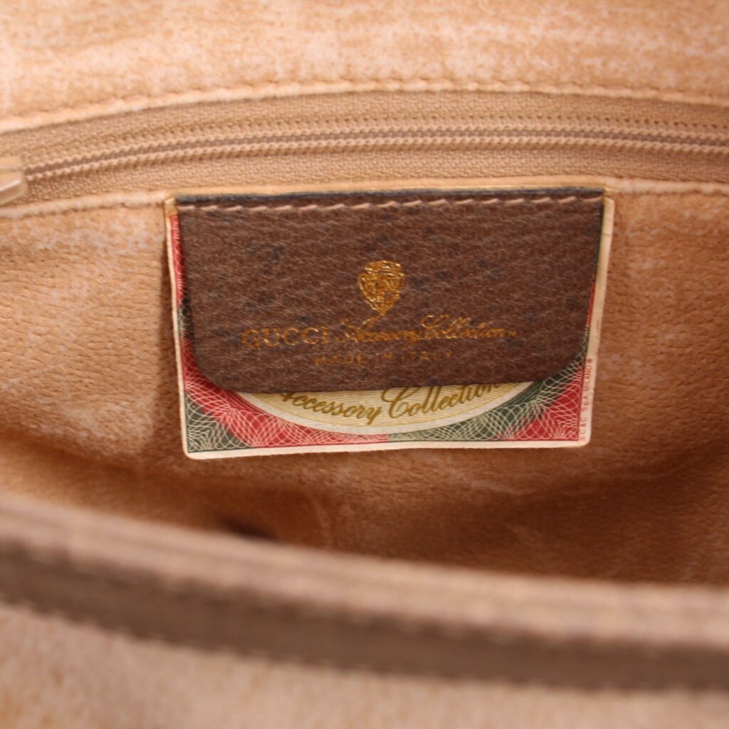 Brown leather logo patch inside bag interior with Gucci writing