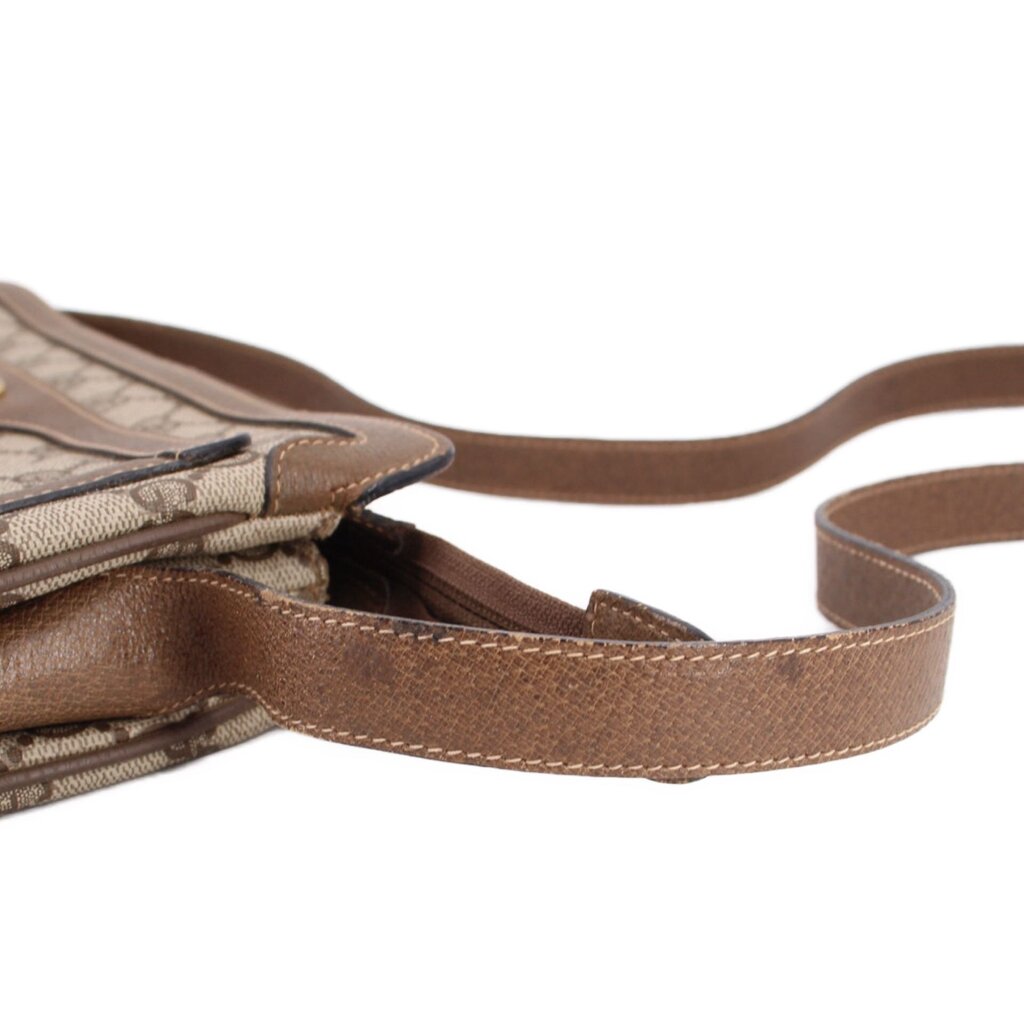 GUCCI GG monogram shoulder bag close-up with brown leather strap and side flap