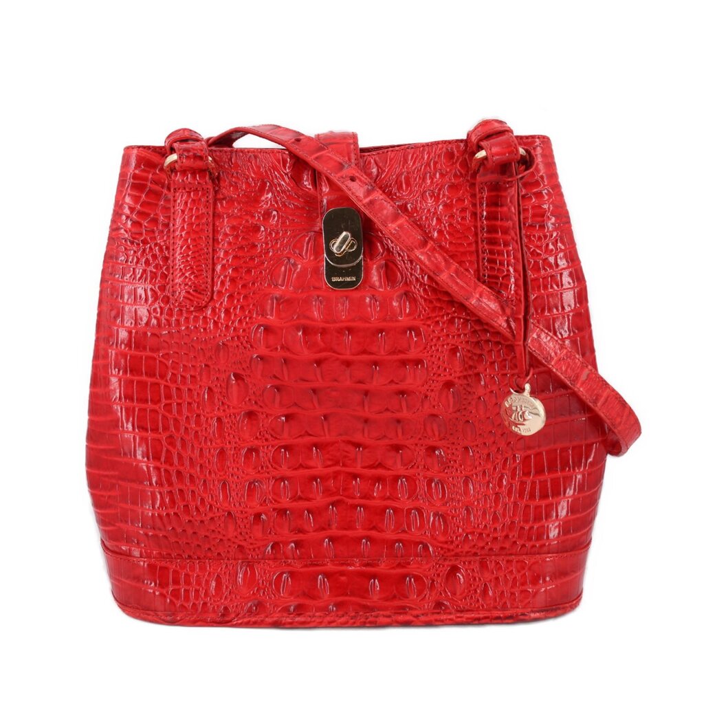 Red croc-embossed bucket shoulder bag with drawstring closure and metal charm tag