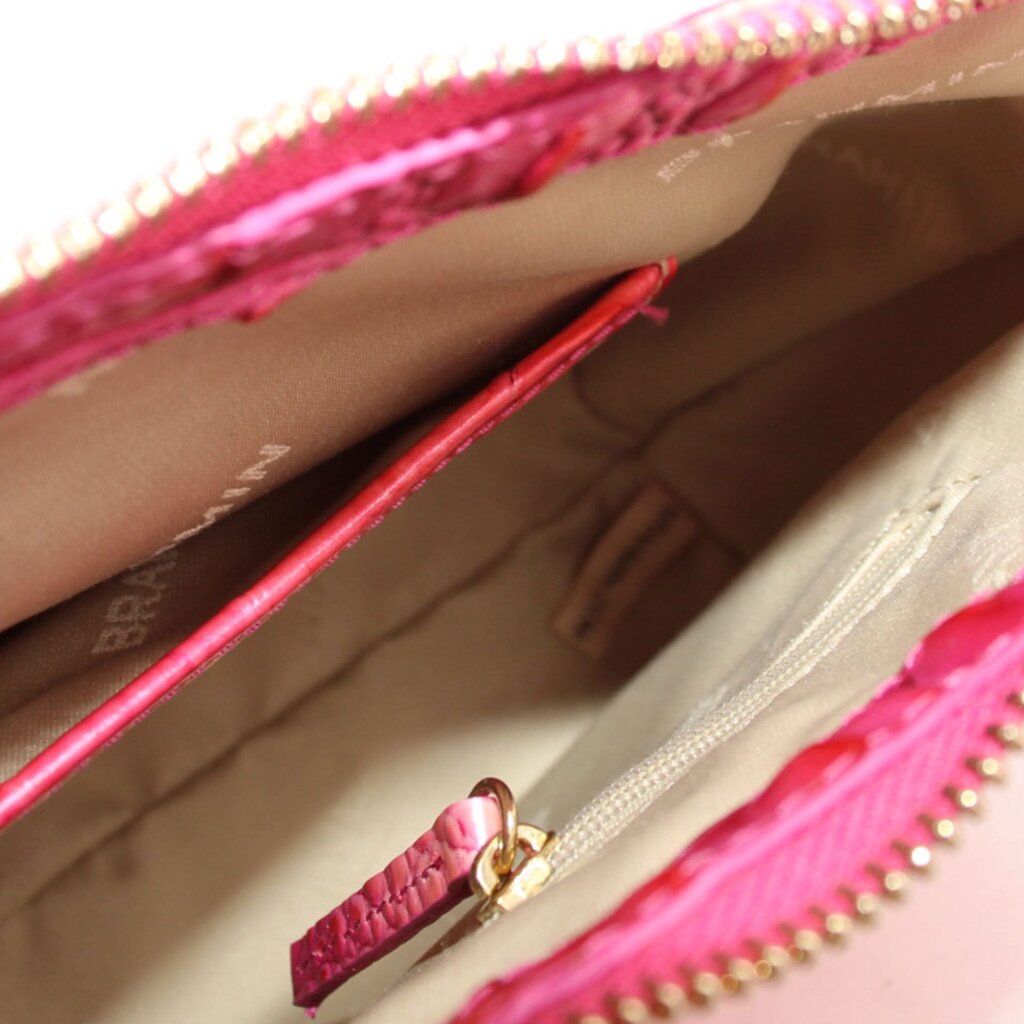 Brahmin Esme small bag interior with pink lining and gold zipper hardware close-up.