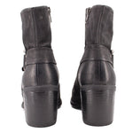 Black leather harness boots, back view with heel and strap hardware