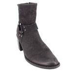 Black leather harness ankle boots with buckle strap across the shaft