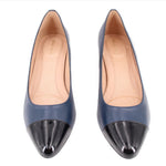 Navy pumps with black cap toes and low block heels, front view pair