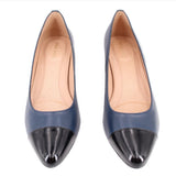 Navy pumps with black cap toes and low block heels, front view pair