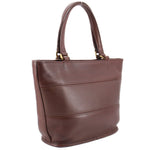 Angled back view of the brown COACH Tribeca shopper bag with stitched panels