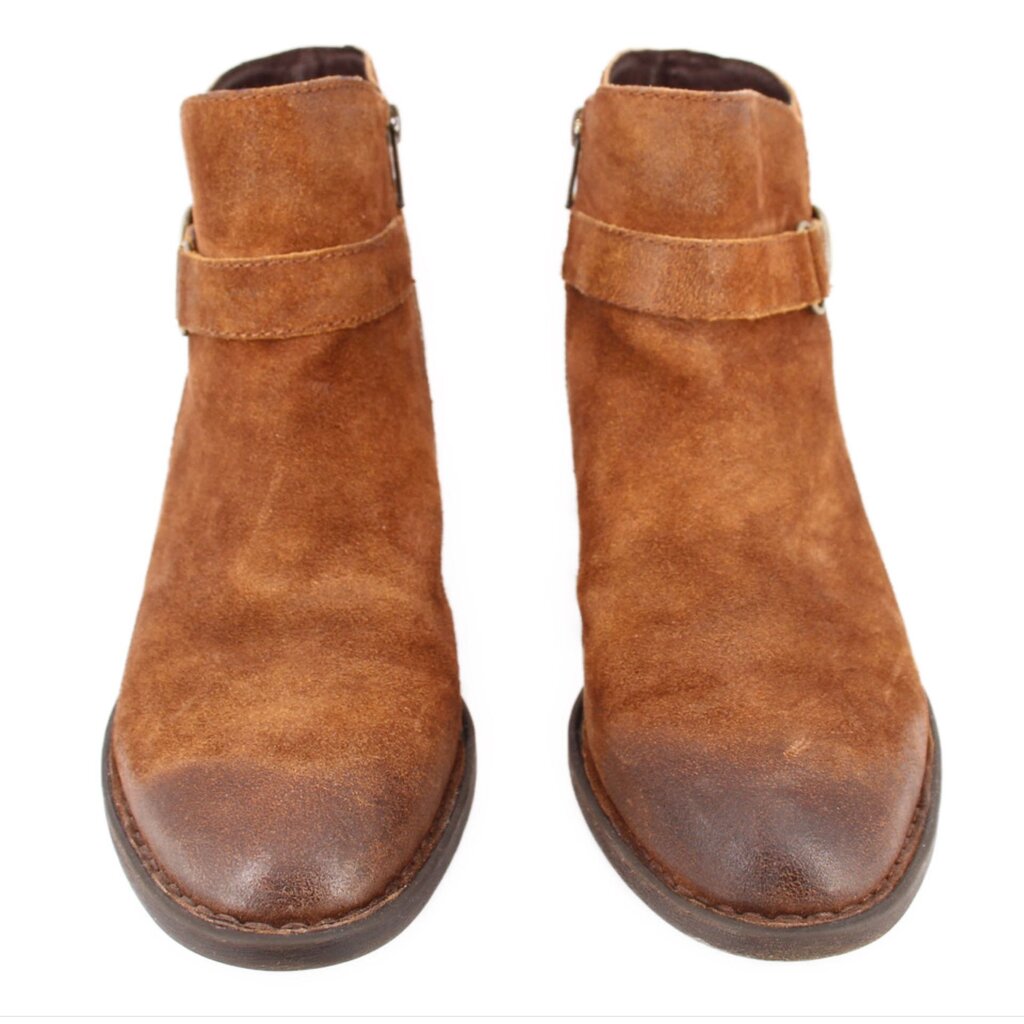Pair of brown suede ankle booties with strap across the shaft