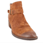 Brown suede ankle bootie with buckle strap and stitched toe