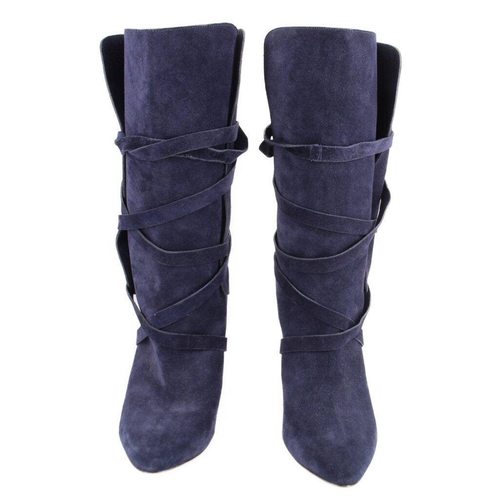 Pair of navy suede slouch boots with pointed toes and wraparound straps