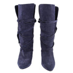 Pair of navy suede slouch boots with pointed toes and wraparound straps
