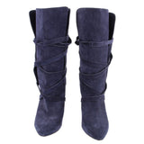 Pair of navy suede slouch boots with pointed toes and wraparound straps