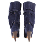 Back view of navy suede slouch boots with wraparound straps and tapered heels