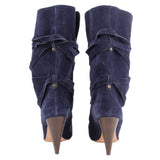 Back view of navy suede slouch boots with wraparound straps and tapered heels