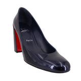 Navy patent leather pointed-toe pump with block heel and red sole trim