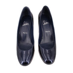 Pair of navy patent leather pointed-toe heels with red outsole accents