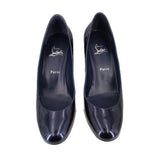 Pair of navy patent leather pointed-toe heels with red outsole accents