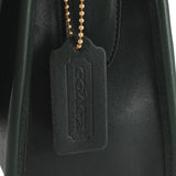 Close-up of the COACH leather hangtag with gold-tone ball chain