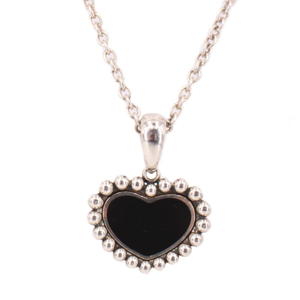 Close-up of the necklace's black heart pendant with a beaded silver-tone border