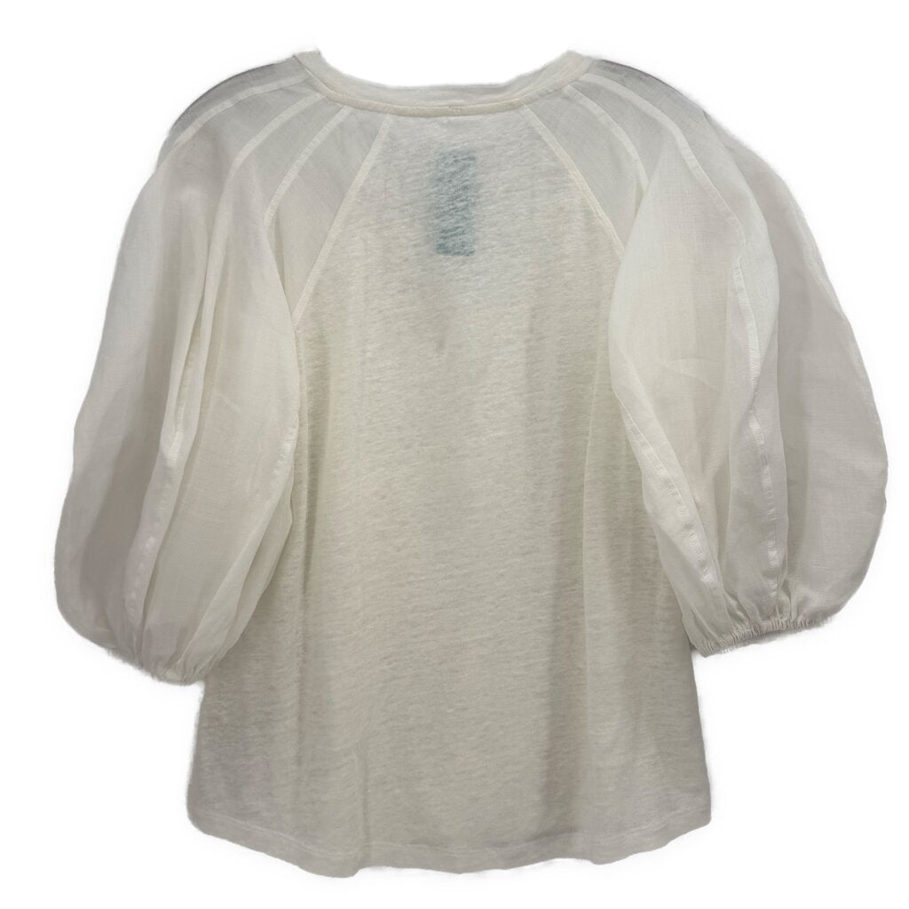 White puff-sleeve top, back view, gathered round neckline and sheer sleeves