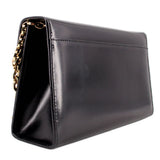 Black leather crossbody bag angled view with gold clasp and chain strap