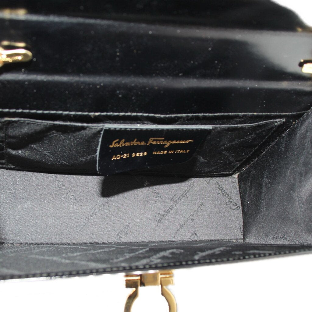 Crossbody bag interior view with brand label and gold clasp hardware