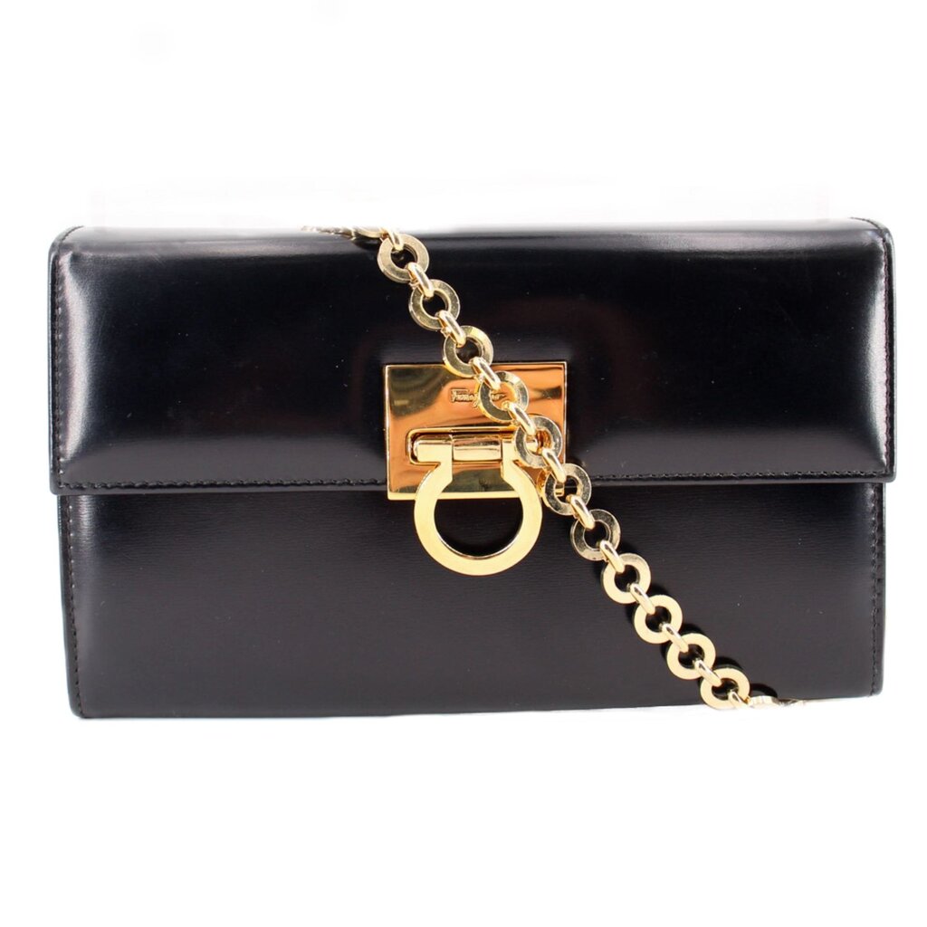 Black leather crossbody bag with gold Gancini-style clasp and chain strap