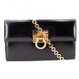 Black leather crossbody bag with gold Gancini-style clasp and chain strap