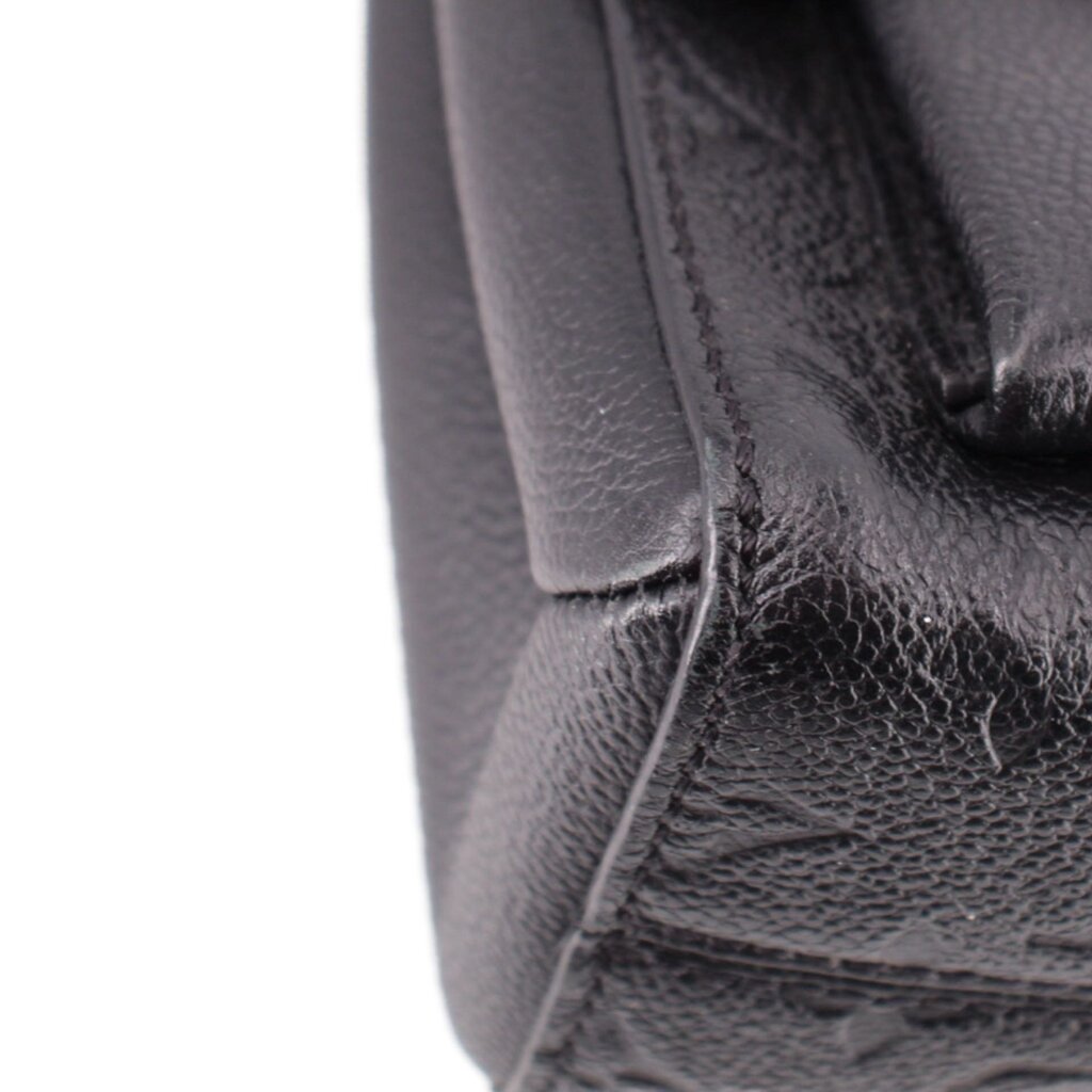 Close-up of black pebbled leather side seam on the LOUIS VUITTON Vavin PM bag