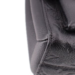 Close-up of black pebbled leather side seam on the LOUIS VUITTON Vavin PM bag