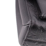 Close-up of black pebbled leather side seam on the LOUIS VUITTON Vavin PM bag