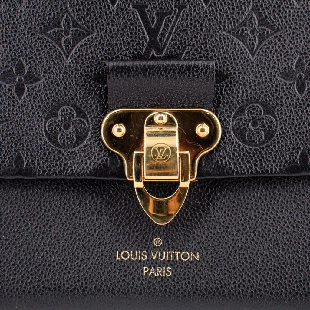 Close-up of the gold clasp and embossed leather on the LOUIS VUITTON Vavin PM bag