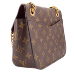Brown monogram crossbody bag side view with flap edge and gold-tone chain