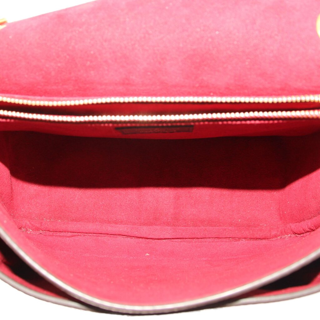Interior view of monogram crossbody bag showing red fabric lining