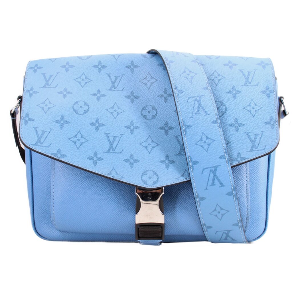 Blue flap crossbody bag with monogram pattern and center snap closure