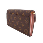 LOUIS VUITTON Sarah wallet, side view: brown monogram canvas with pink interior