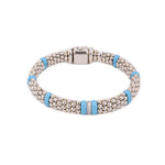 Sterling silver bead bracelet with blue ceramic spacers and a diamond-accented center station