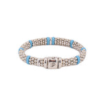 Sterling silver bead bracelet with blue ceramic spacers and a prominent clasp