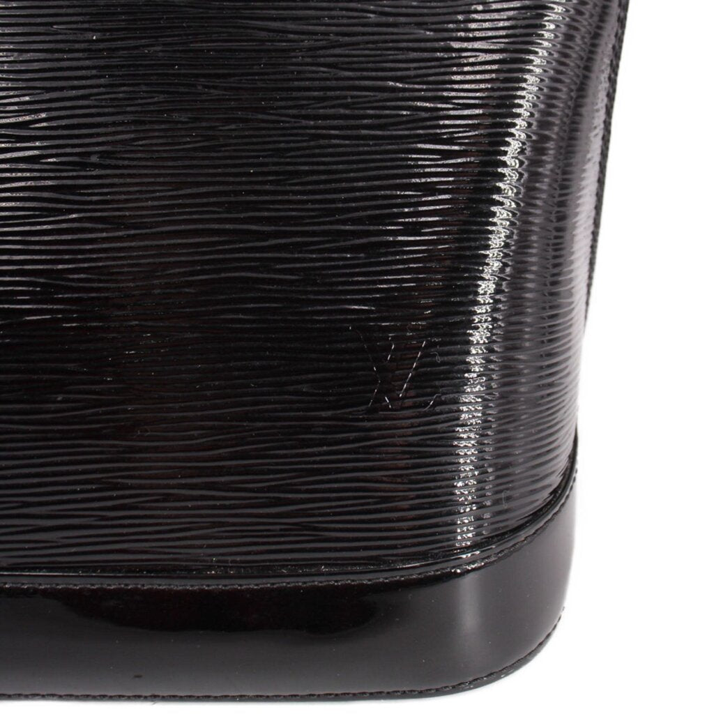 Louis Vuitton Alma GM handbag, close-up of glossy ribbed black surface and base trim