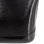 Louis Vuitton Alma GM handbag, close-up of glossy ribbed black surface and base trim