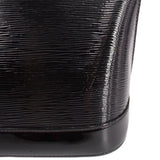 Louis Vuitton Alma GM handbag, close-up of glossy ribbed black surface and base trim