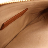 Beige lining and stitched interior pocket inside brown shoulder bag